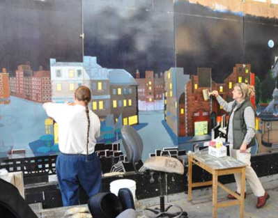 James Norton and Laurie Brooks painting a mural - Photo by Steve Emrick